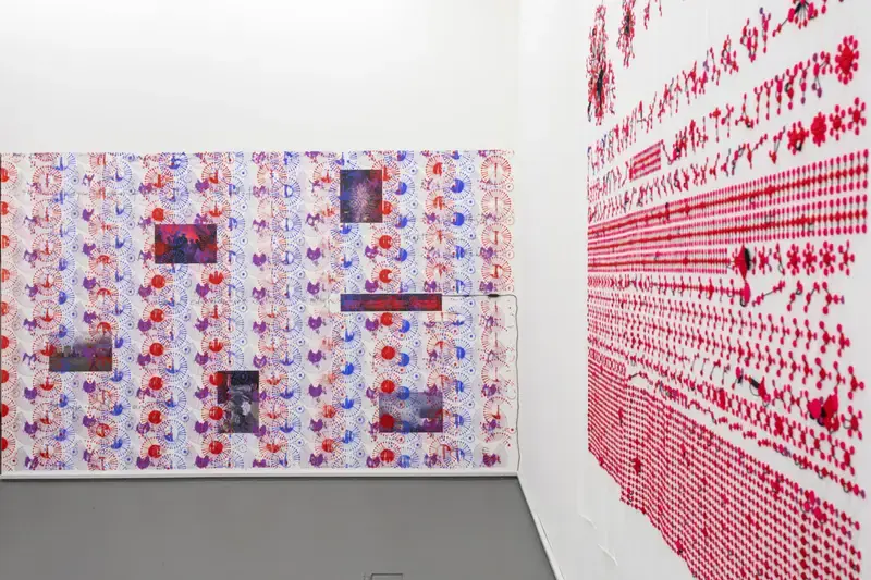 Gallery room with walls printed in red and blue network patterns