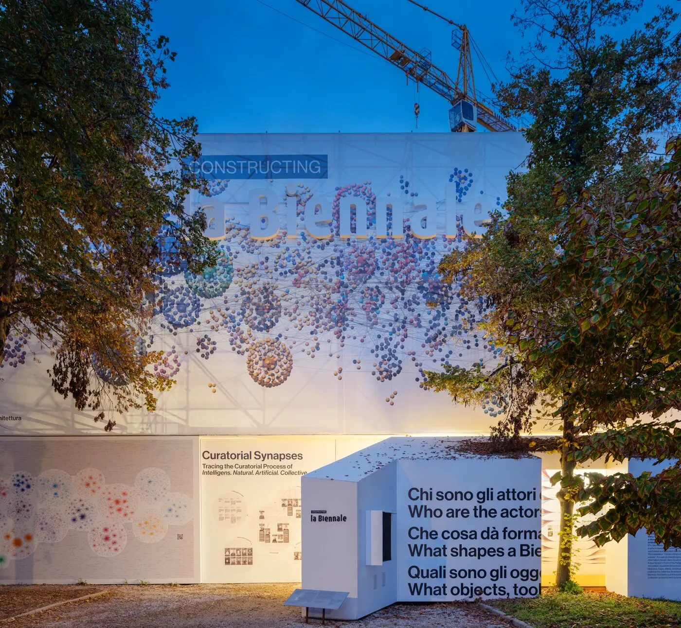 Constructing La Biennale at dusk, Venice: a network of coloured spheres printed across the pavilion facade
