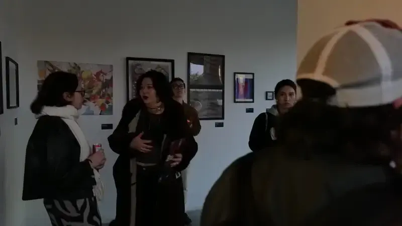 Exhibition opening: visitors in front of the Home Is Where prints